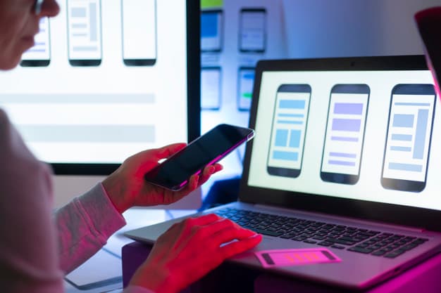 woman using phone and computer